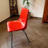 Pair of red plastic chairs with metal frame
