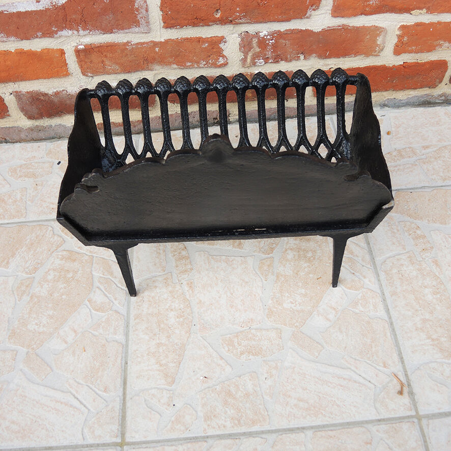 Old cast iron log cradle with backrest