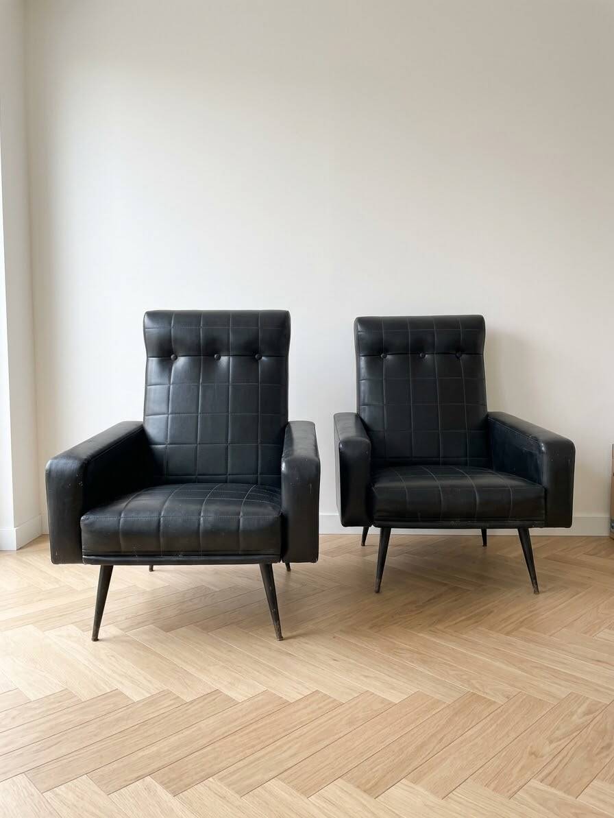 Pair of vintage 70s armchairs in black faux leather.