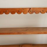 Vintage pine wall shelf with a scalloped front.