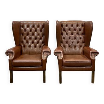 Pair of brown leather wingback Chesterfield armchairs from the 1970s.