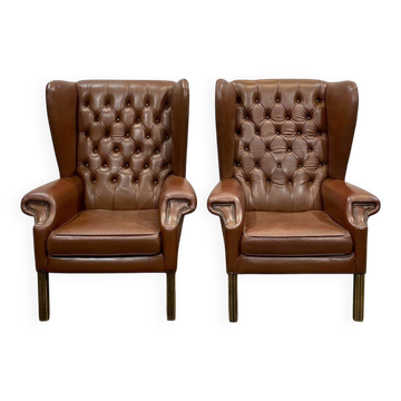 Pair of brown leather wingback Chesterfield armchairs from the 1970s.