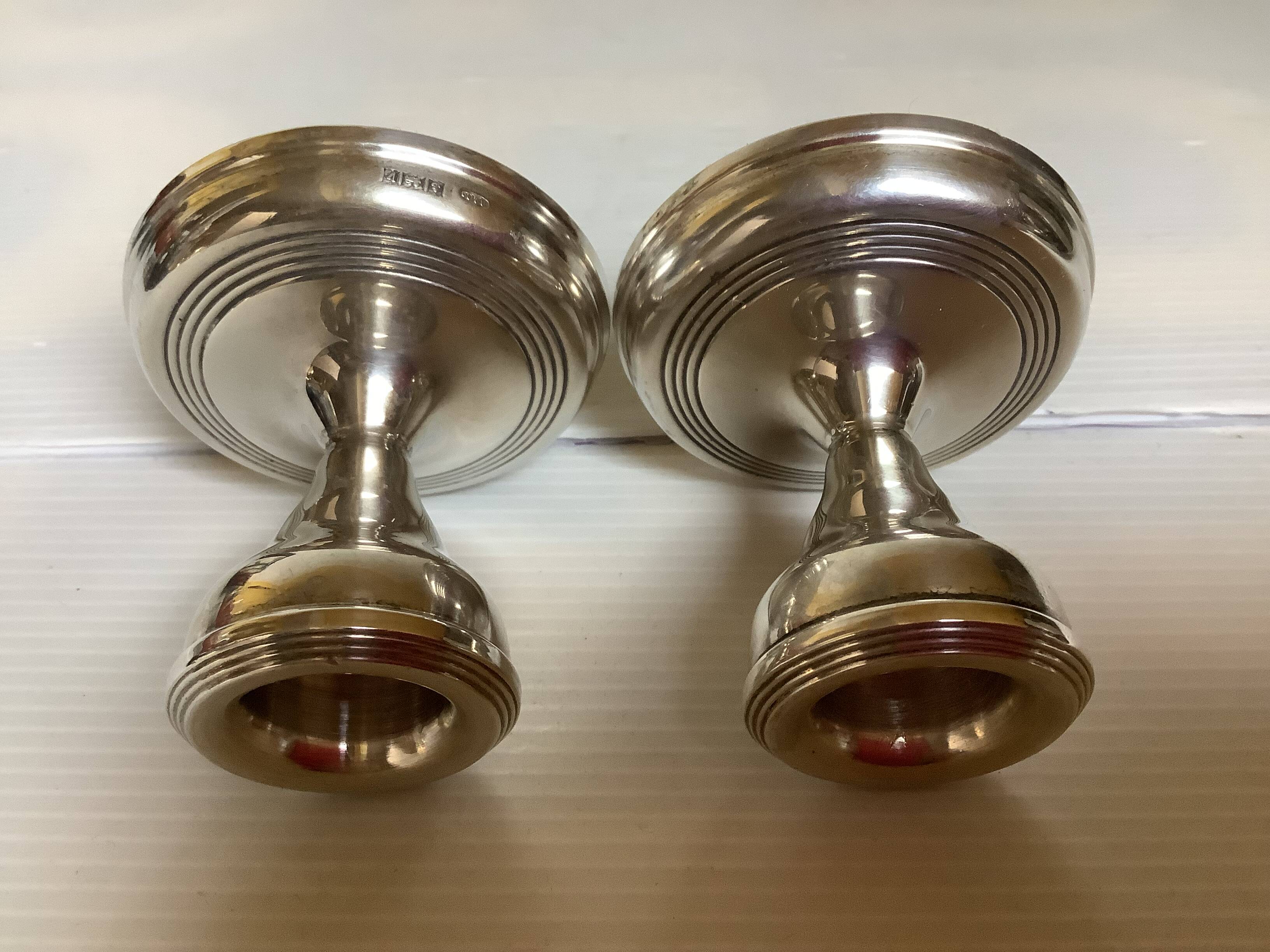 Pair of small silver candlesticks with hallmarks