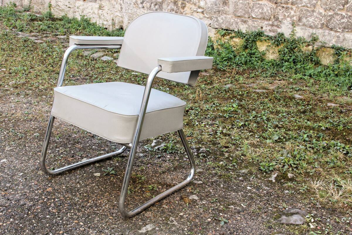 Set of 2 chairs and 1 armchair from the 70s in chrome metal and faux leather.
