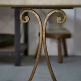 Side table with a gilt wrought iron base attributed to Gilbert Poillerat, with a travertine top, 1940s