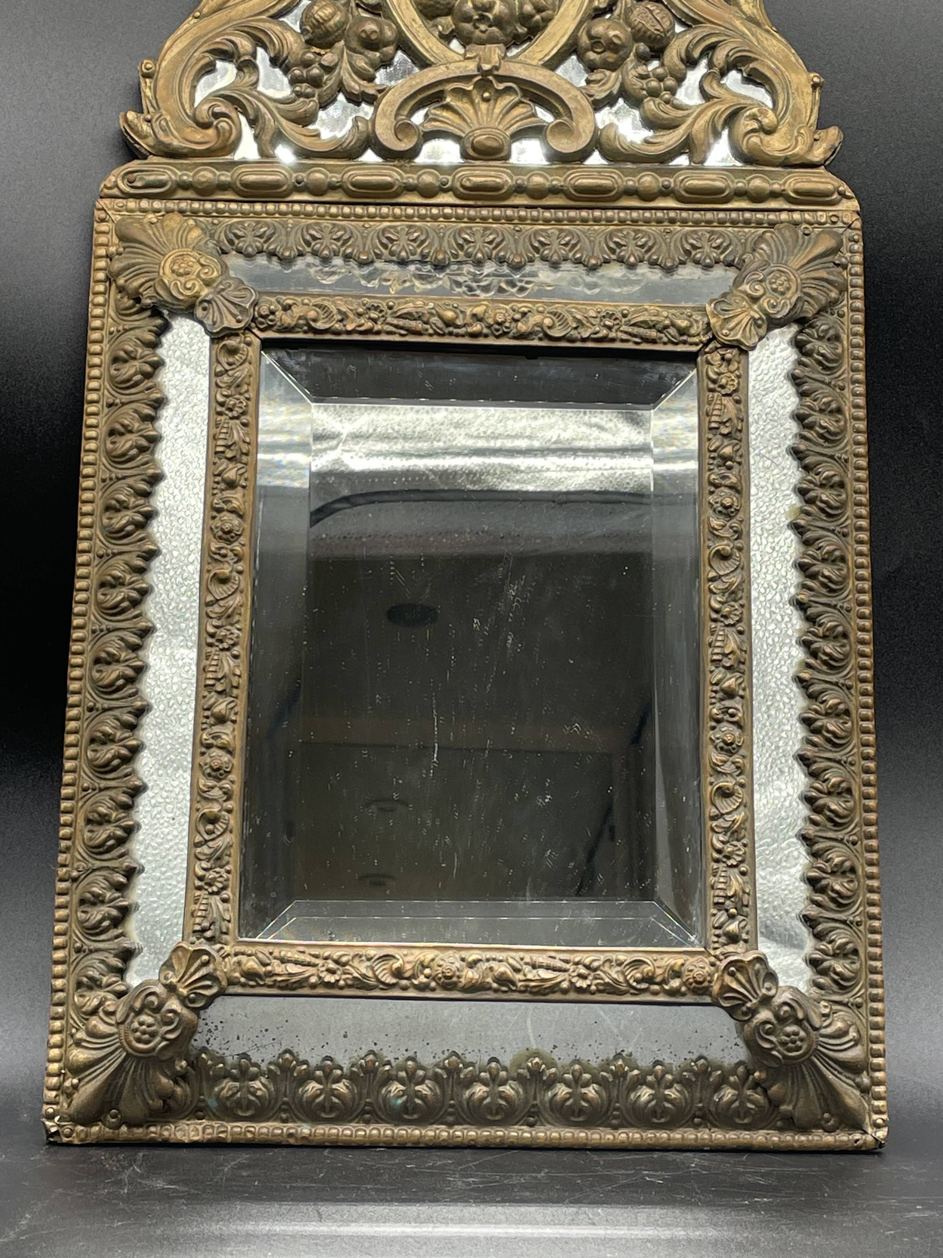 Small mirror with brass parcloses in repoussé style Louis XIV, late 19th century.