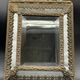 Small mirror with brass parcloses in repoussé style Louis XIV, late 19th century.