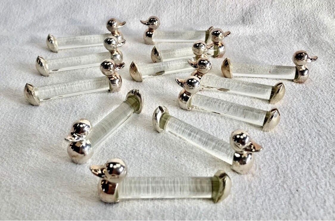 12 silver-plated metal duck knife rests with crystal.