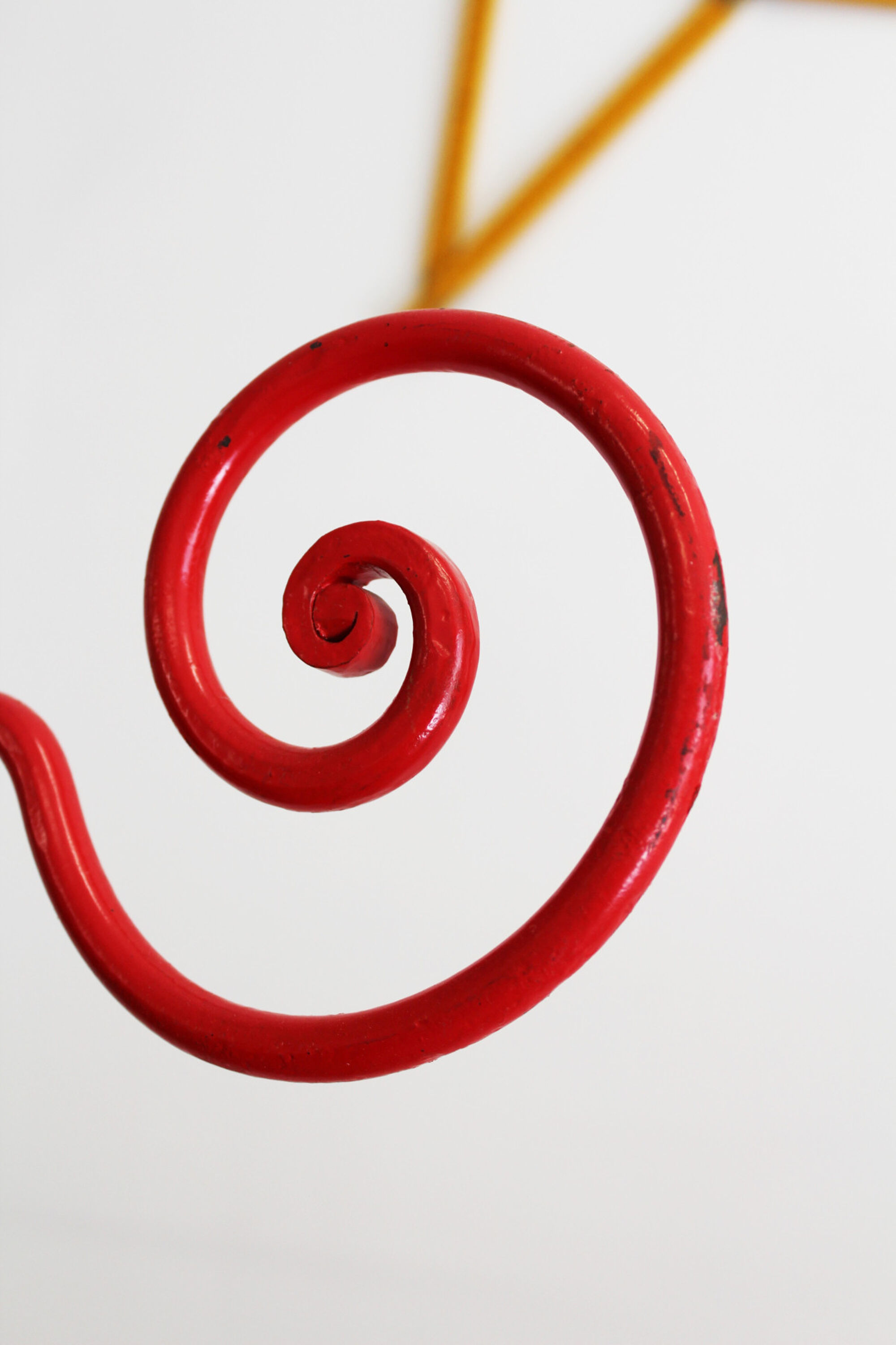 Baby cradle in red wrought iron