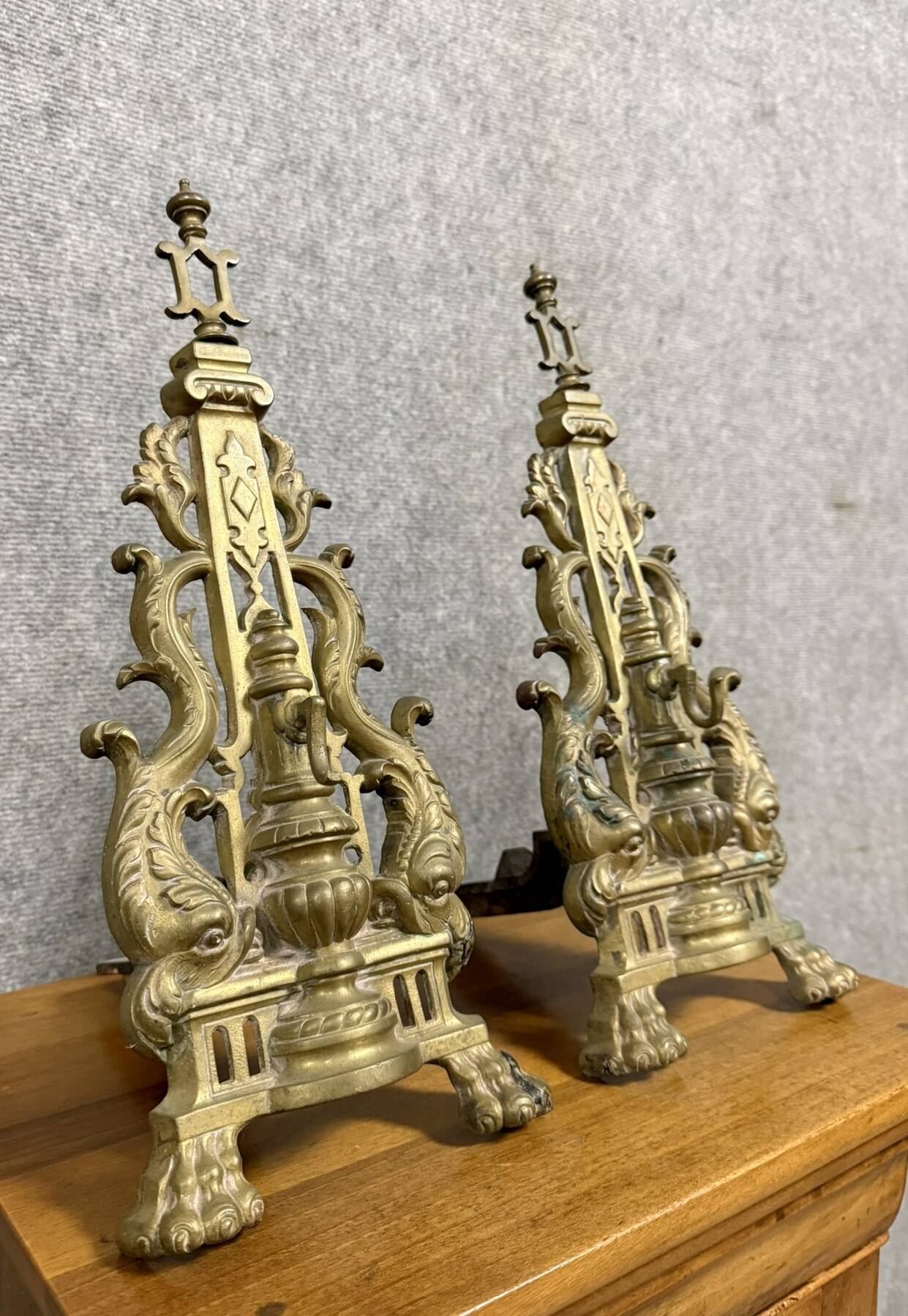 pair of Empire period dolphin firedogs in gilded bronze