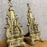 pair of Empire period dolphin firedogs in gilded bronze