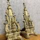 pair of Empire period dolphin firedogs in gilded bronze
