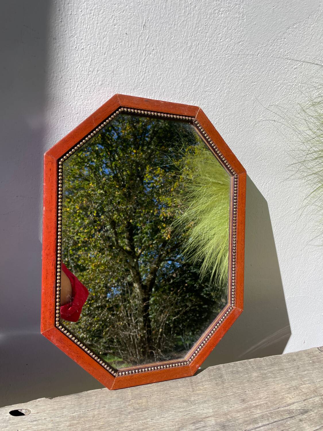 Octagonal beaded wooden mirror