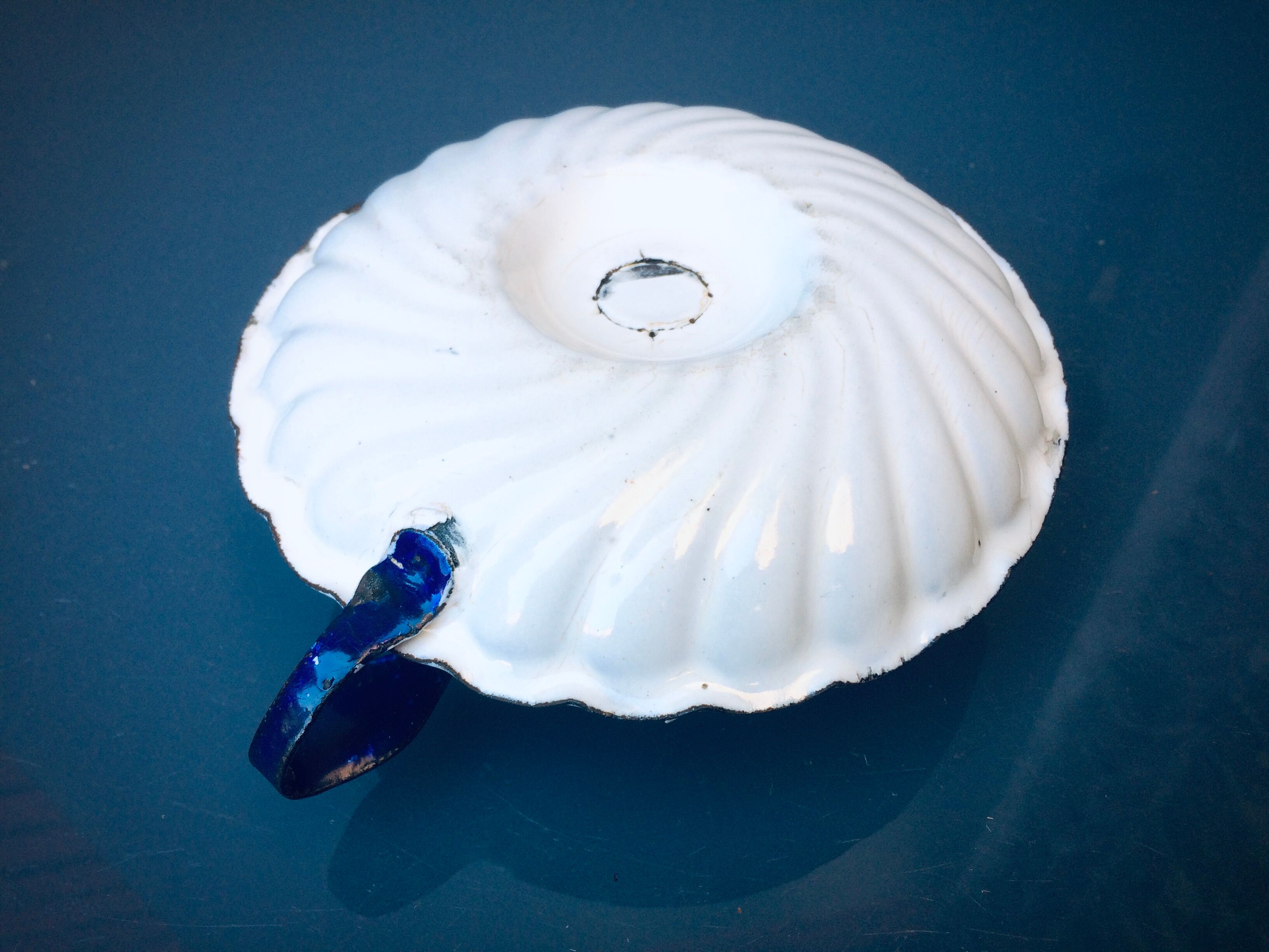 Old white enamelled candlestick