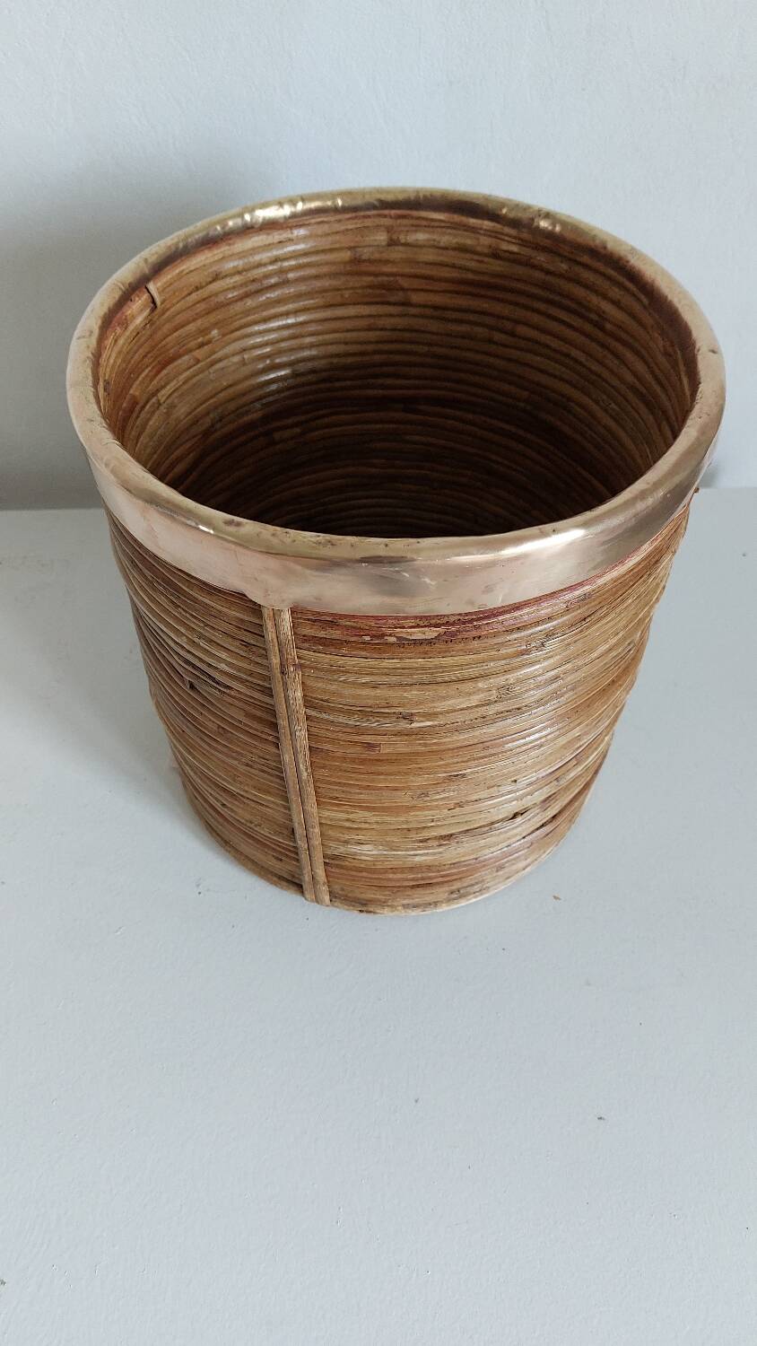Rattan and brass pot cover