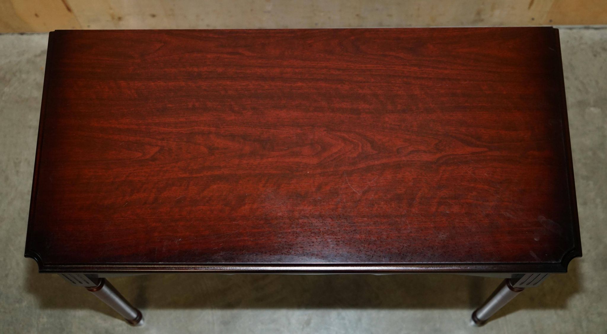 Small console with two drawers in hardwood finish.