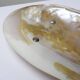 Antique mother-of-pearl tripod bowl emptier with silver metal legs