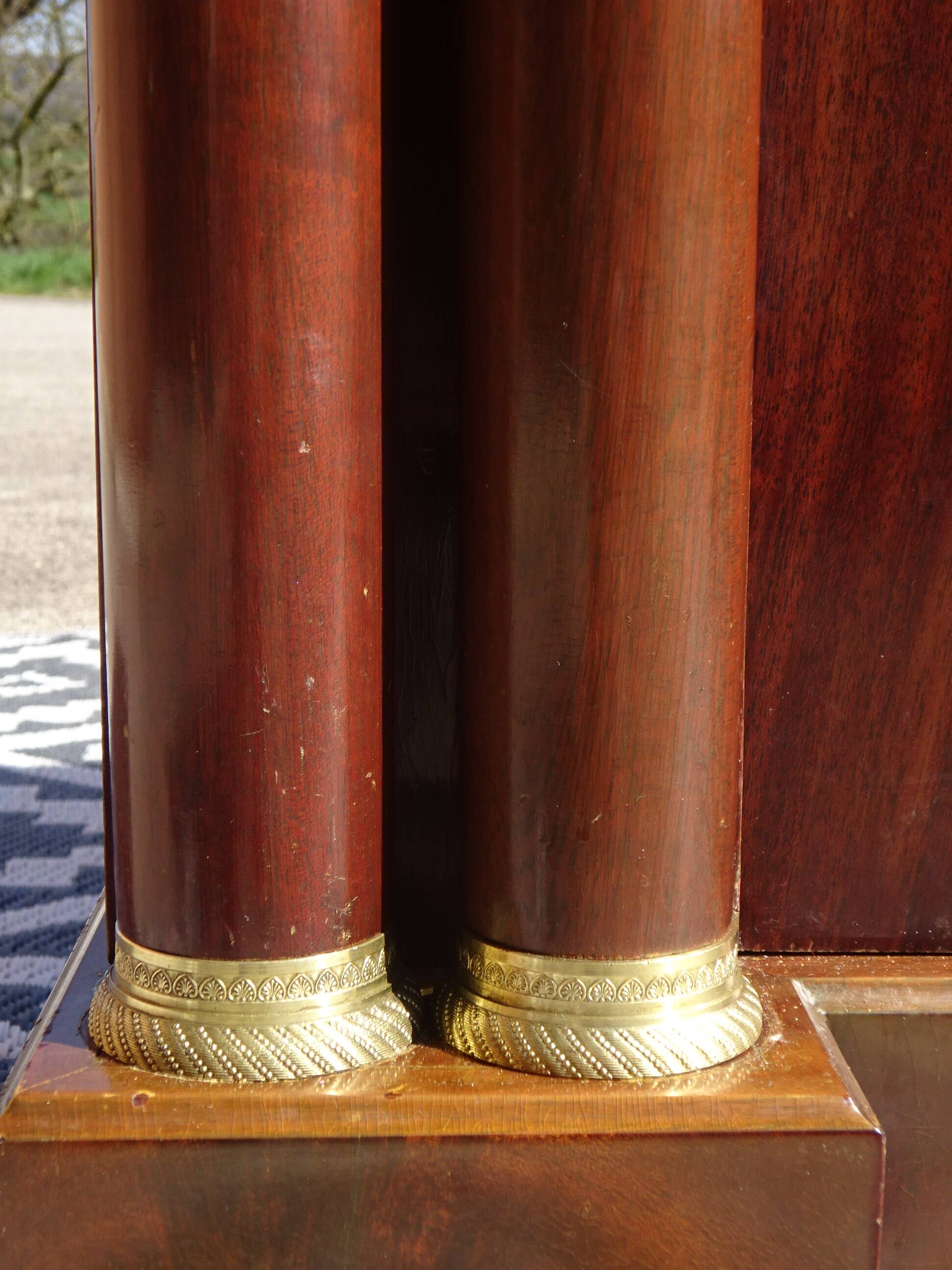 Flamed mahogany enfilade with sea green marble in Empire style.