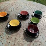 Coffee service composed of 5 cups and saucers in black earthenware and different colored interiors