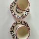 Pair of HB Quimper egg cups with integrated pedestal base, floral decoration