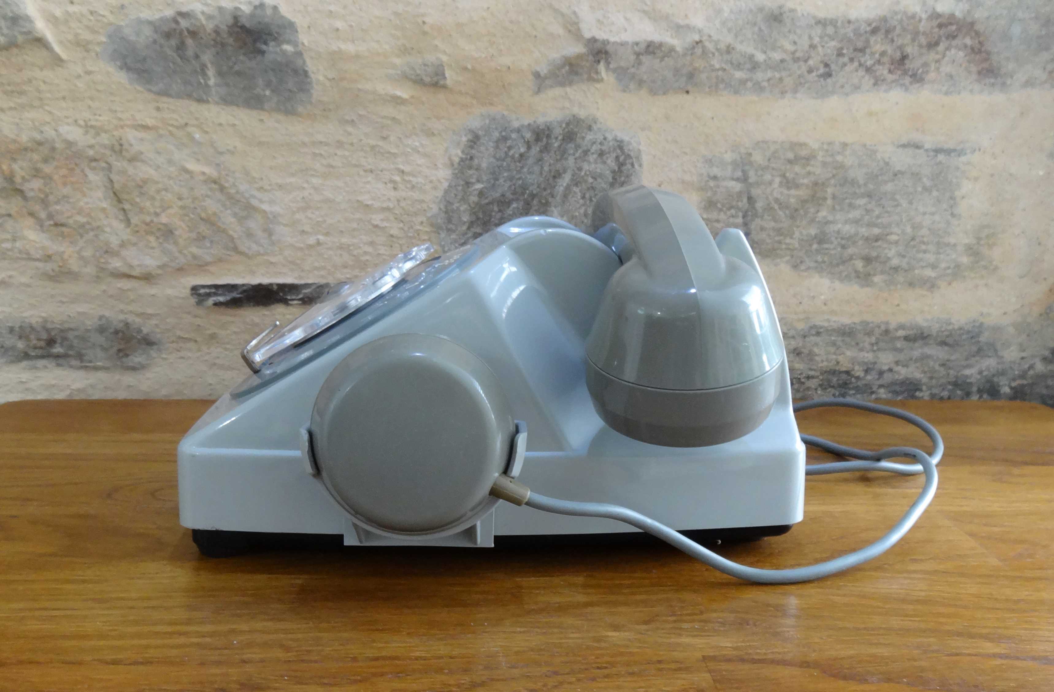 Grey vintage rotary dial phone with earpiece