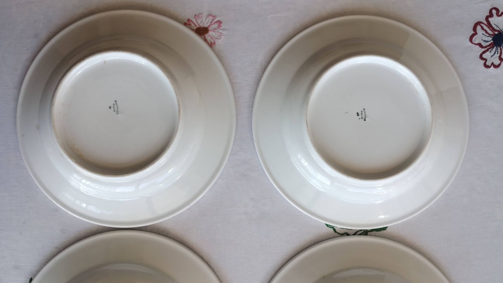 3 Pillivuyt white porcelain dinner plates with blue edging.