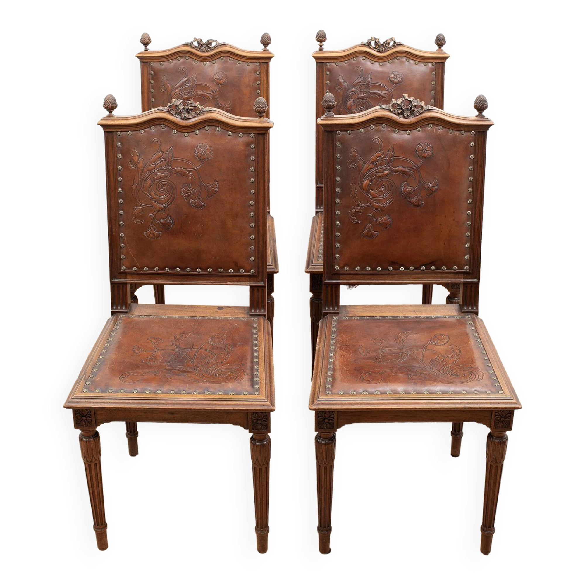 Set of 4 Louis XVI style chairs in carved wood and embossed leather.