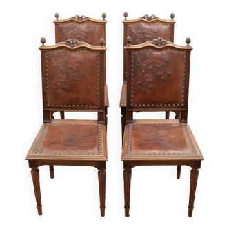 Set of 4 Louis XVI style chairs in carved wood and embossed leather.