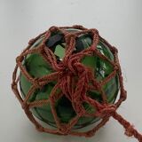Globe, green glass float and vintage rope