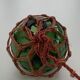 Globe, green glass float and vintage rope