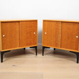 A pair of vintage mid-century bedside tables with oak sliding doors