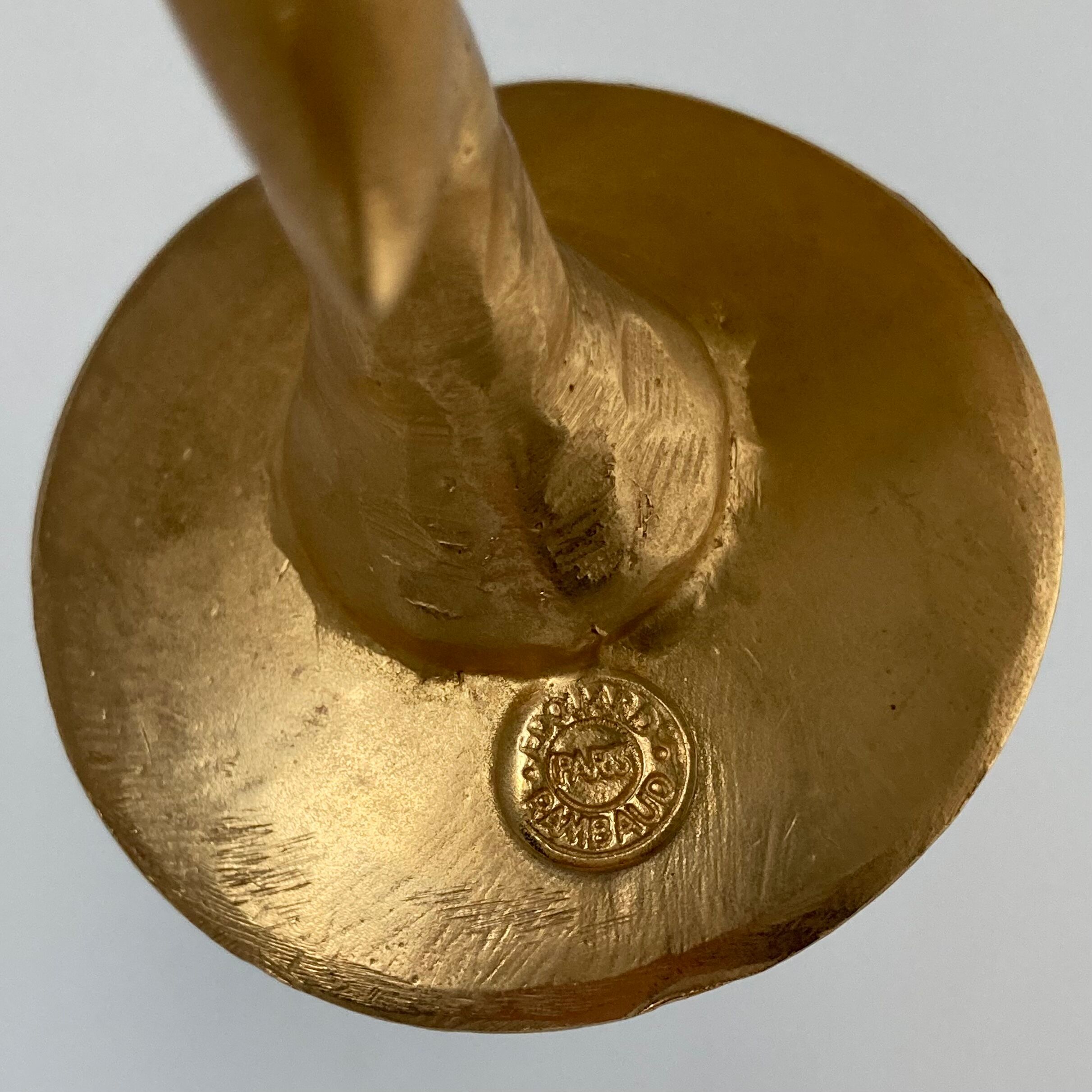 Paire de bougeoirs lune et soleil en métal doré par Édouard Rambaud