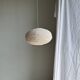 Average suspension in natural rattan and linen, Japanese-style, flattened oval in pink.