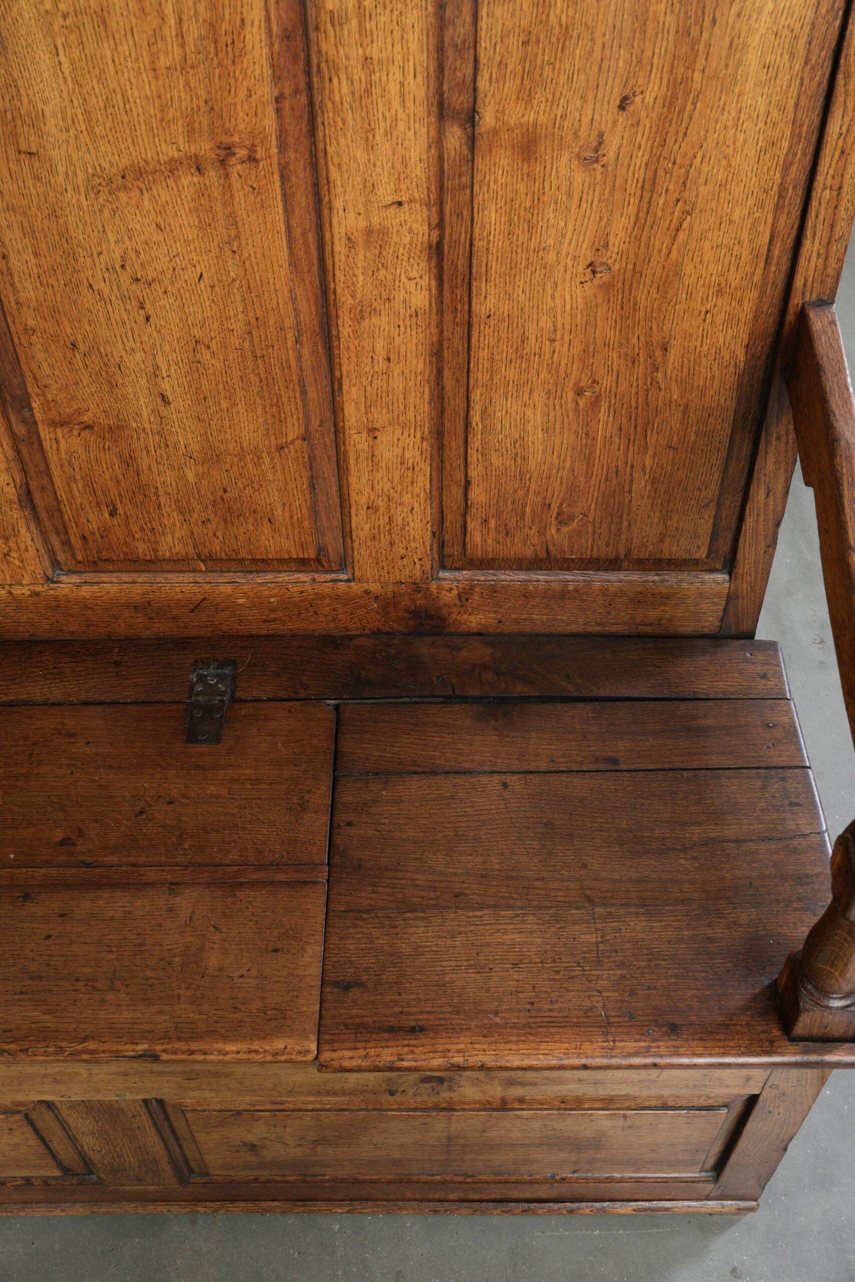 Antique English oak hall bench from the early 19th century with storage space