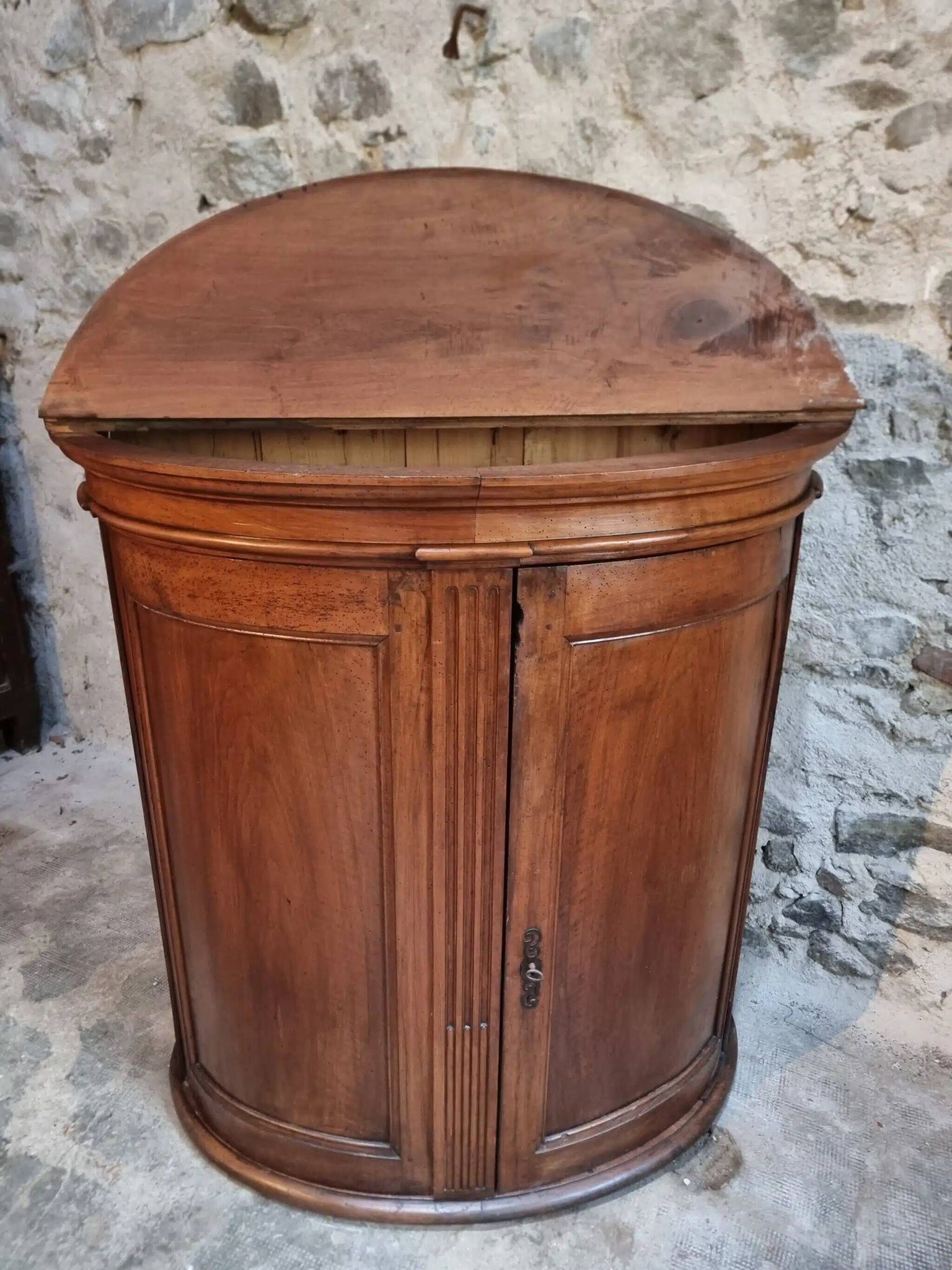 Antique demi-lune cabinet in walnut, late 18th century, French château.