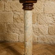 Wood and lacquer pedestal column table mimicking marble, 19th century.