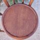 pair of round wooden chairs with a pattern on the seat