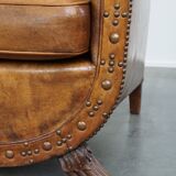 Characteristic antique sheepskin leather armchair with beautiful details and a unique design