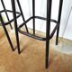 Pair of black metal bar stools and yellow imitation leather seat