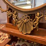 Miroir ovale en laiton doré , figures de chérubins et moulures
