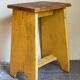 Art-populaire workshop stool in patinated painted wood