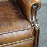 Fauteuil à oreilles en cuir de mouton