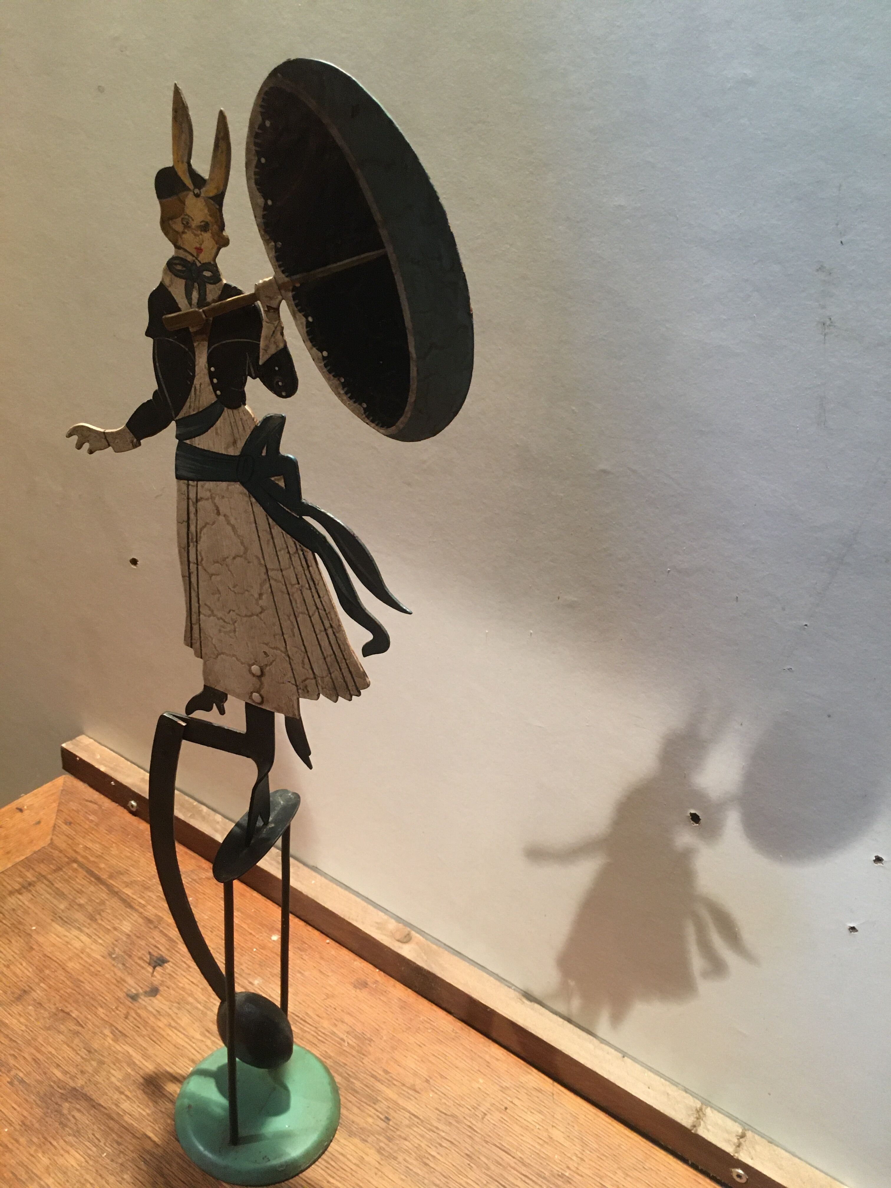 Woman with metal umbrella, pendulum