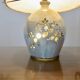 Ceramic lamp with double lighting and openwork design.