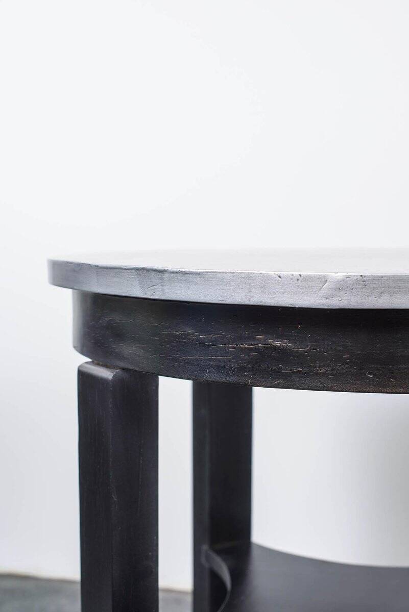 Round Art Deco black painted wooden side table with lower shelf, 1930s.