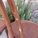pair of round wooden chairs with a pattern on the seat