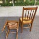 Solid wood chair with a straw seat and carved bar backrest.