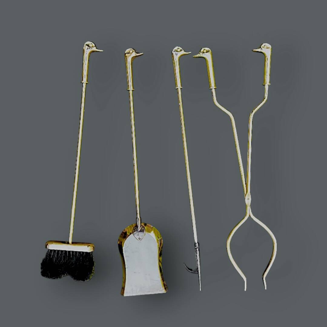 Antique fireplace tool in gilded zamak with duck head designs.