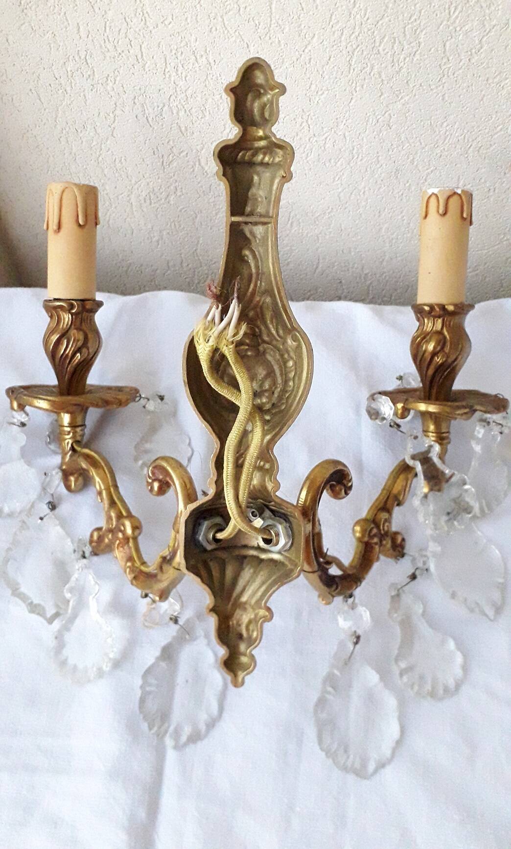pair of bronze wall lights with pendants