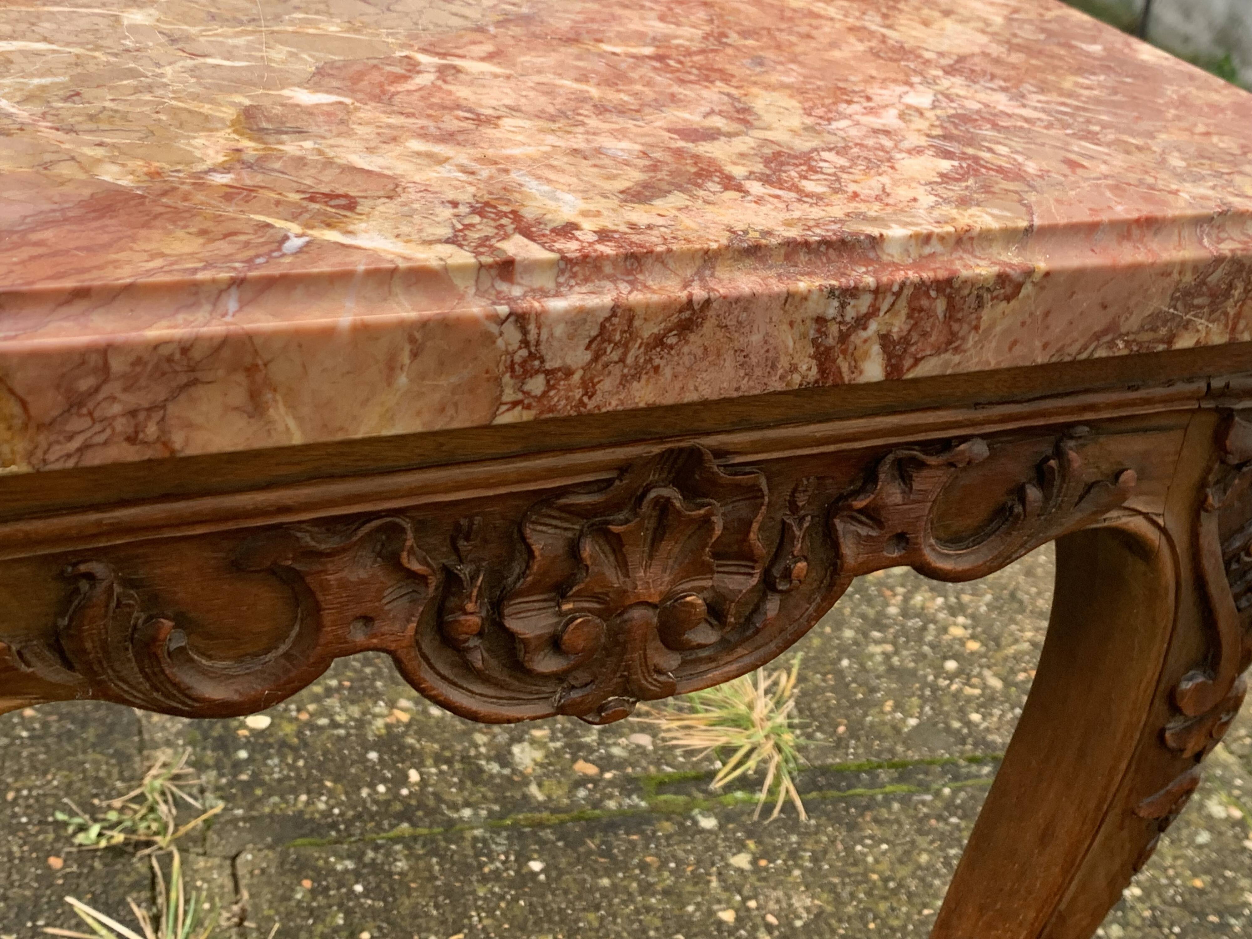 Carved wooden coffee table with shell pattern and removable pink marble top, old